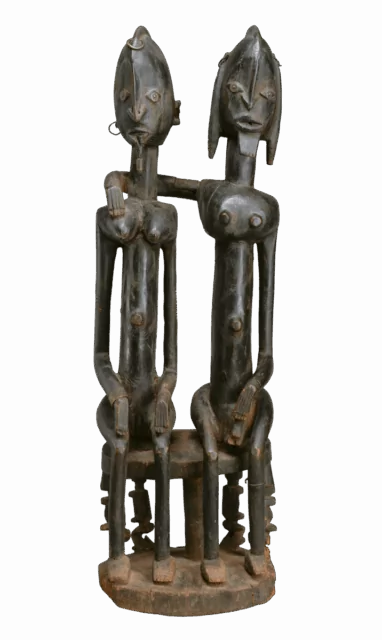 Title: Seated couple Artist: "Barnes Foundation Master" (active late 18th–early 19th century[?], Bandiagara Escarpment, Mali) Date: 18th–early 19th century Geography: Mali, Bandiagara Escarpment Culture: Dogon Medium: Wood, copper and iron alloy, applied organic materials Dimensions: H. 28 3/4 × W. 8 5/8 × D. 8 in. (73 × 21.9 × 20.3 cm) Classification: Wood-Sculpture