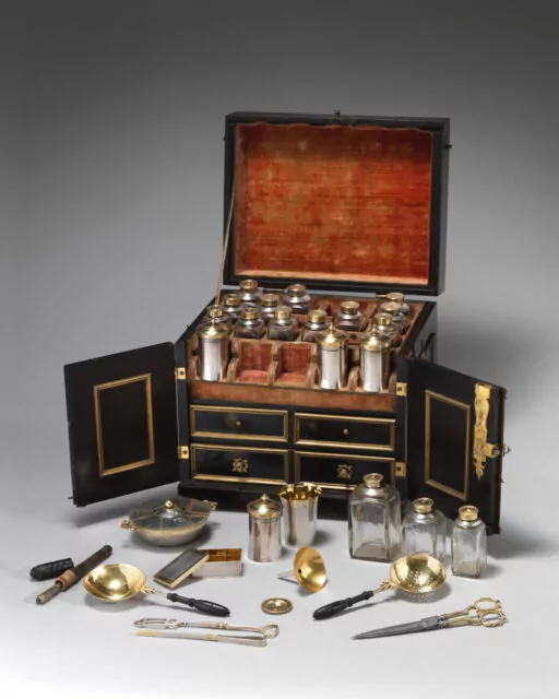 German Ebonized Pearwood Apothecary Cabinet, Circa 1617, gold fittings by Goldsmith: Nicolaus I Kolb (German, master 1582–1621).Medium: Veneer: ebonized pearwood (Pyrus communis), ebony, partially gilded silver; carcass: conifer; interior: protective quilted cushion covered in red silk, drawers and chest lined with red silk velvet; gold trimming; mounts and fittings: partially gilded brass; thirty-two (32) vessels and utensils: glass, partially gilded silver, low carbon steel, leather