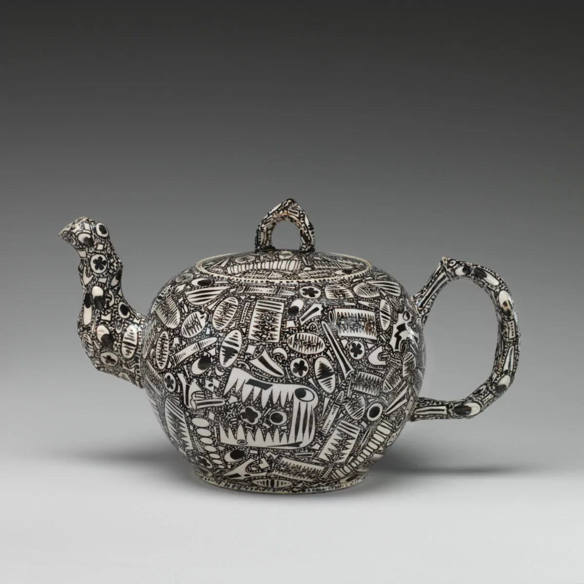 George III Staffordshire salt-glaze teapot with enamel fossil decoration pattern, circa 1760-1765.