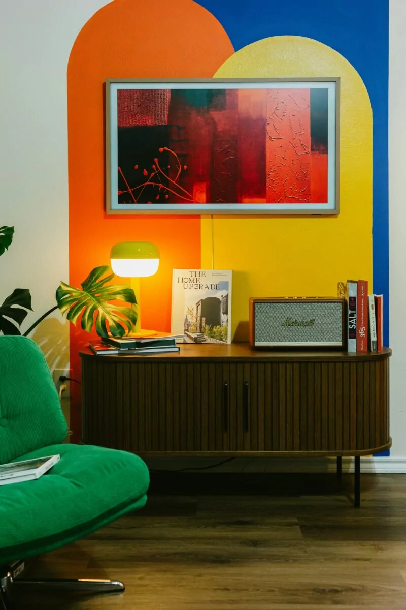 fujiphilm-tpHDuQxF_tE-unsplash Mid century modern interior showing artwork, lounge chair and sideboard